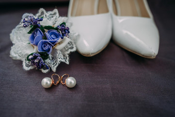 Fototapeta na wymiar Bride accessories: lace blouse, garter, ballet flats, high-heeled shoes