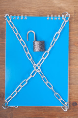 Blue notebook, tied with chains with lock