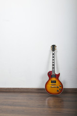 Vintage electric guitar about a white wall
