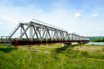 Railway bridge over the river, which flows from the mountains in the Carpathian region. Ukraine
