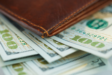 Brown leather wallet with USA dollars money