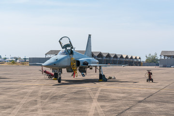 Fototapeta premium F-5E Aggressor Hornet fighter jet reflects the sunshine. F-5 military aircraft parked in the airport and flight show.
