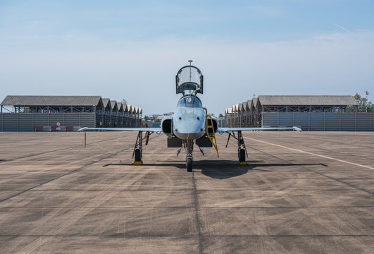 F-5E Aggressor Hornet fighter jet reflects the sunshine.
F-5 military aircraft parked in the airport and flight show.