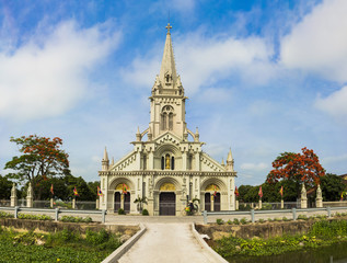 Fototapeta na wymiar Panorama view of a commune church in Kim Son district, Ninh Binh province, Vietnam. The building is a travel destination for tourist visiting Ninh Binh