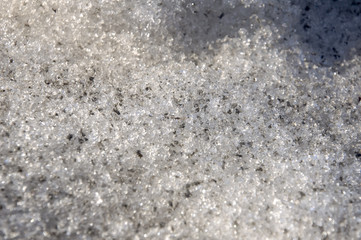 Snow with ice like a glass and crystal in early spring