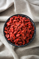 Wolfberries or Goji berries in bowl on tablecloth
