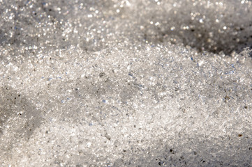 Snow with ice like a glass and crystal in early spring