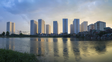 Apartment with reflection on lake. Hanoi buildings