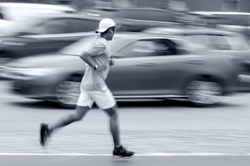 athlete runner on city street in blue tonality
