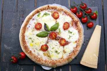 Hot true PEPPERONI ITALIAN PIZZA with salami and cheese. TOP VIEW Tasty traditional pepperoni pizza on board on wooden table with decoration
