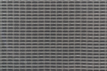 Abstract techno background with interwoven gray shiny metal wire, closeup