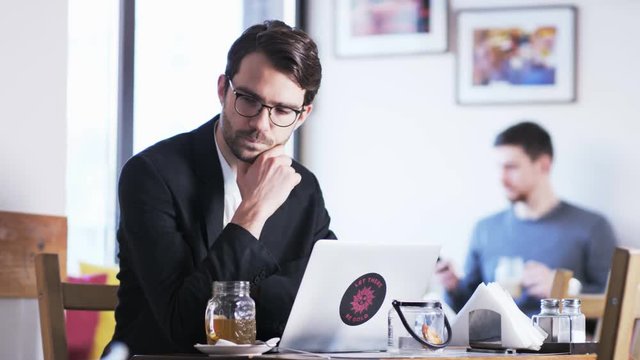 Worried Young Businessman in a Cafe