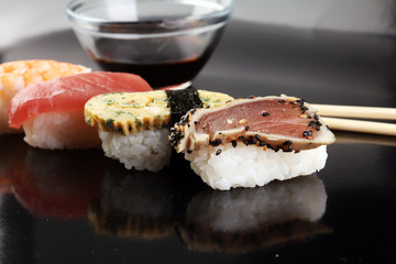 close up of sashimi sushi set with chopsticks and soy - sushi roll with salmon and sushi roll with smoked eel, selective focus.
