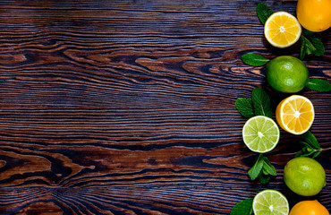 Fresh lemon and lime with mint leaves on the wooden table