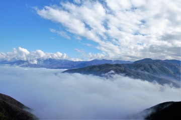 Fototapeta na wymiar View over the clouds on top of the hill Cerro Arco close to Mendoza in Argentina, South America