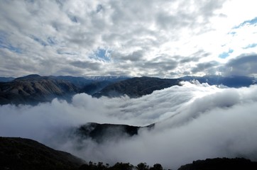 View over the clouds on top of the hill Cerro Arco close to Mendoza in Argentina, South America