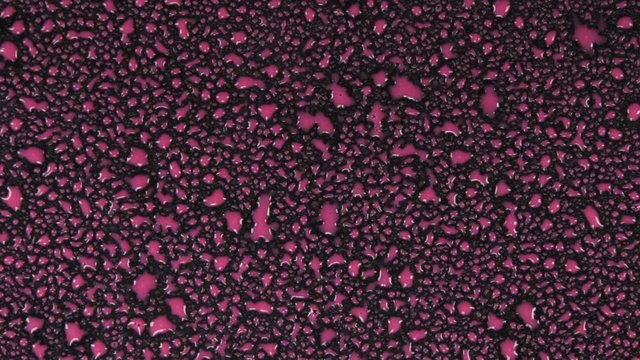 Falling and approximation by drops of pink paint on a black surface.