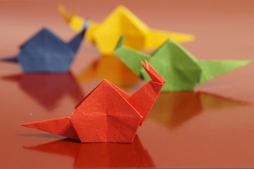 Paper origami snail isolated on a colorful background
