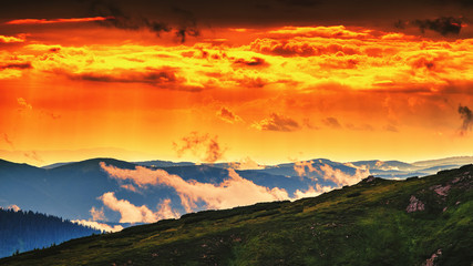 Fototapeta na wymiar Red, orange sky in sunset evening time, picturesque and dramatic Carpathian mountains landscape, Ukraine.