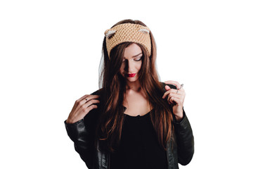 Pretty young woman wearing a hand knitted beige hat on white background. Isolated. Beautiful girl in with Ear flap,