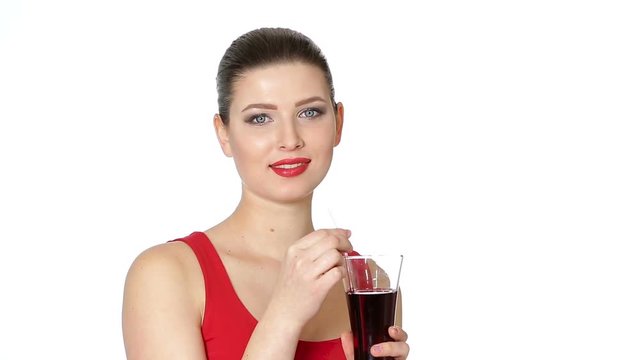 brunette woman drinking cherry juice from glass