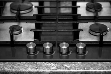 modern gas stove burners and control knobs