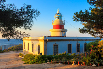 Lighthouse in the rays of the rising sun