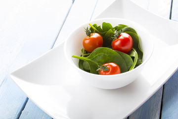 spinach tomato salad food fresh healthy cook rustic wooden background
