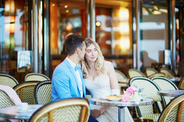 Just married couple in traditional Parisian cafe