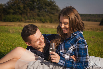 happy couple lying on the grass in the sunny day