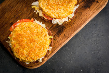 Modern Asian cuisine Ramen burger: a sandwich with bread noodle, was used instead of buns. Copy space, top view