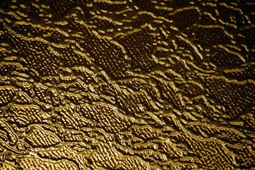 Gold glass with abstract patterns background