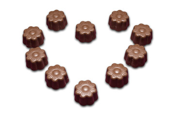 chocolate flowers forming heart isolated on white