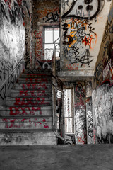 staircase, stairs in run down building with graffiti -