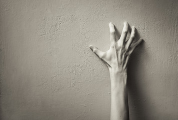 Hand clawing up a wall. Frustration, and anger concept. 
