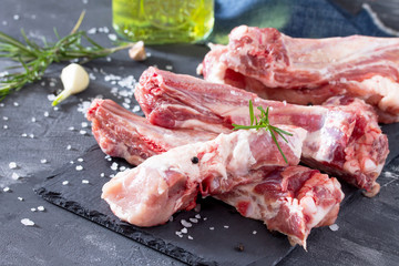 Raw meat on the bone with olive oil, fresh herbs and spices. Hea