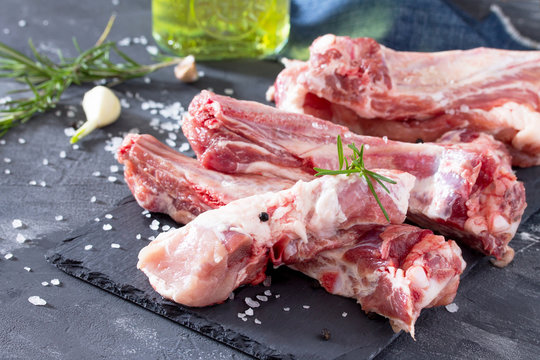 Raw meat on the bone with olive oil, fresh herbs and spices. Hea