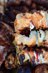 Skewers on wooden stick with tasty pork meat and vegetables mix