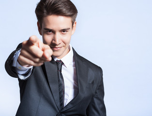 We want you! Making a choice concept. Businessman pointing his finger at camera. 