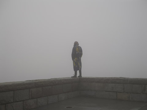 Man in trench coat thinks about the abyss of life