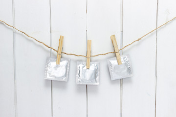 close up of a condom and  clothes peg on white background with clipping path