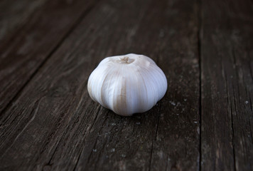 fresh garlic on the wooden background.