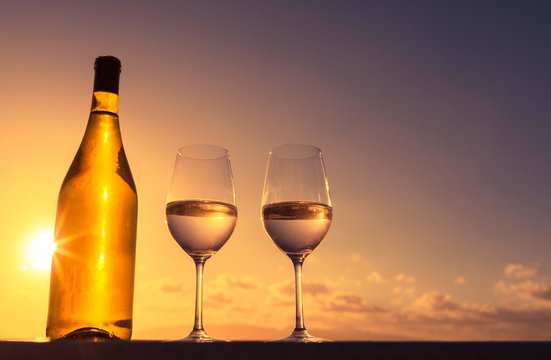 Romantic relaxing setting. Enjoy the beautiful sunset and a glass of wine concept.  