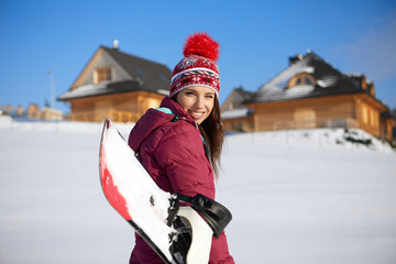 Sport woman  snowboarder on snow over blue sky