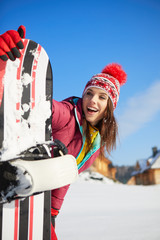 Sport woman  snowboarder on snow over blue sky