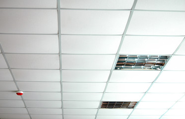 Interior of white false ceiling with lamps 