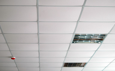 Interior of white false ceiling with lamps 