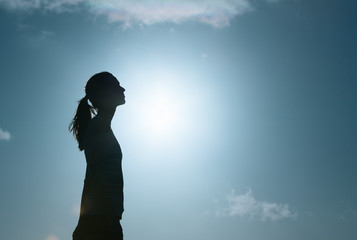 Thoughtful woman looking up into the sky. 