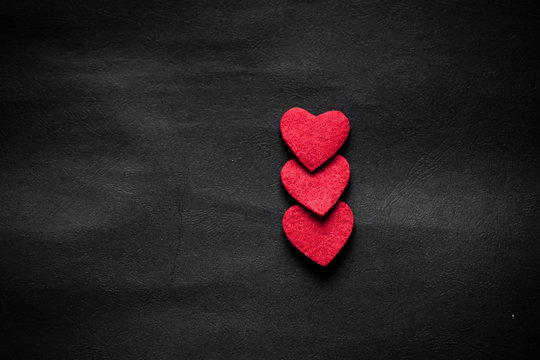 Three Red Hearts On Black Paper