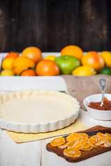 production of cake with citrus marmalade and slices of mandarin